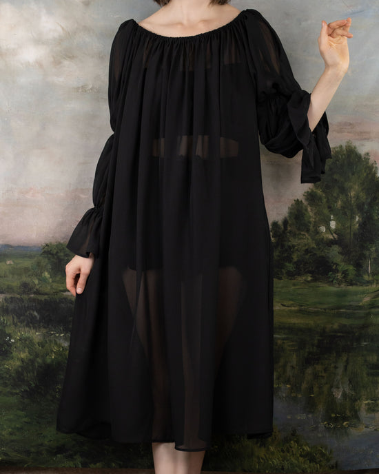 model wearing see thru black chiffon dress