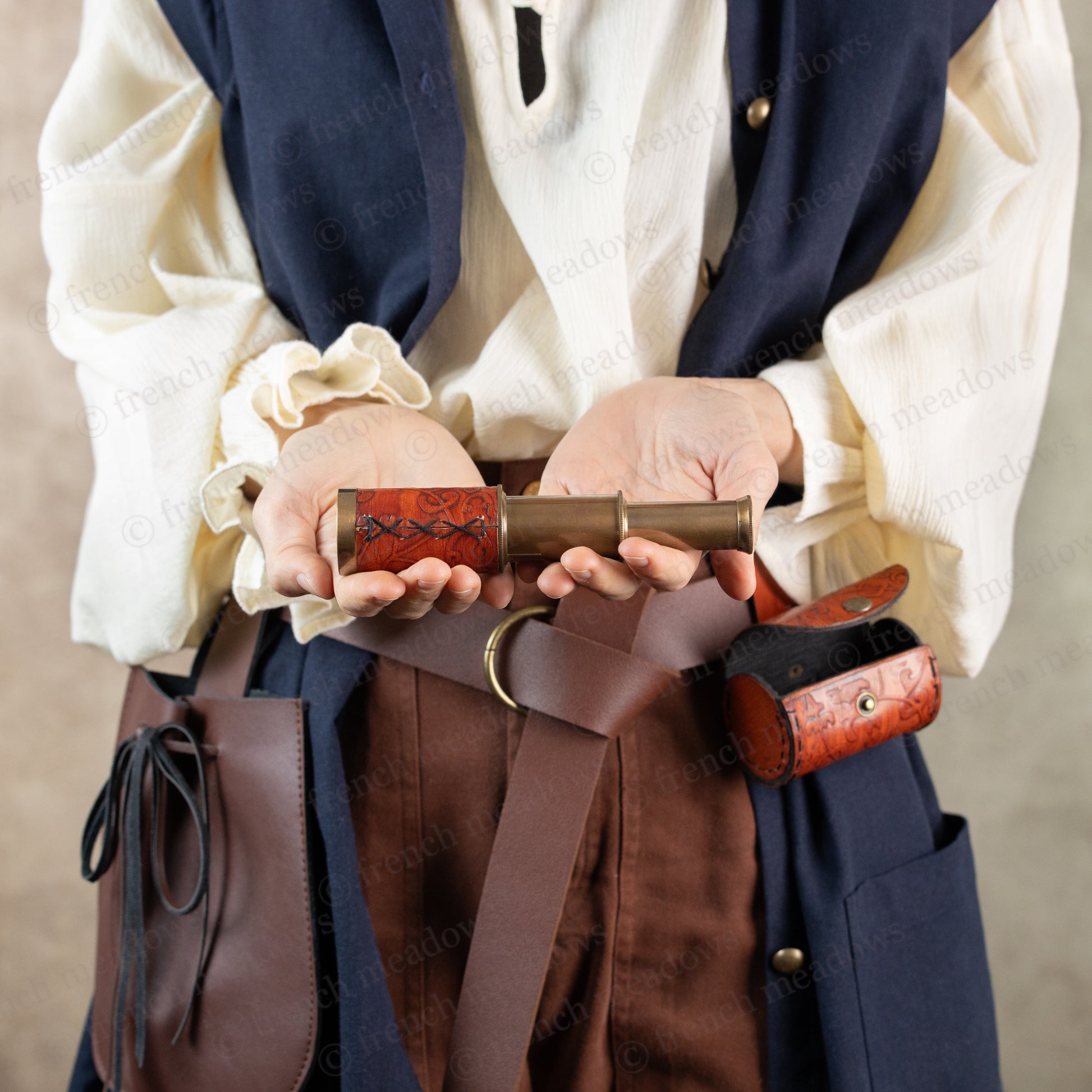 model holding extended spyglass in both hands to show stitch work detail