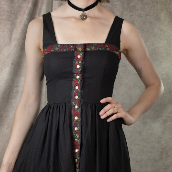 close up view of ribbon detail on black dirndl dress