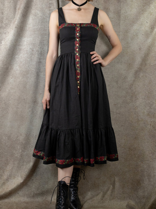 model wearing black ribbon dress with pointy black witch shoes and black velvet choker