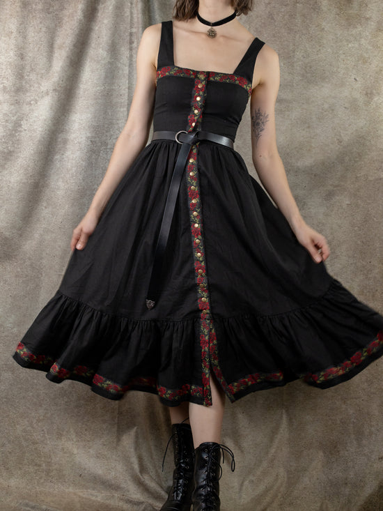 model spinning in black corset dress to show skirt fullness and a-line shape