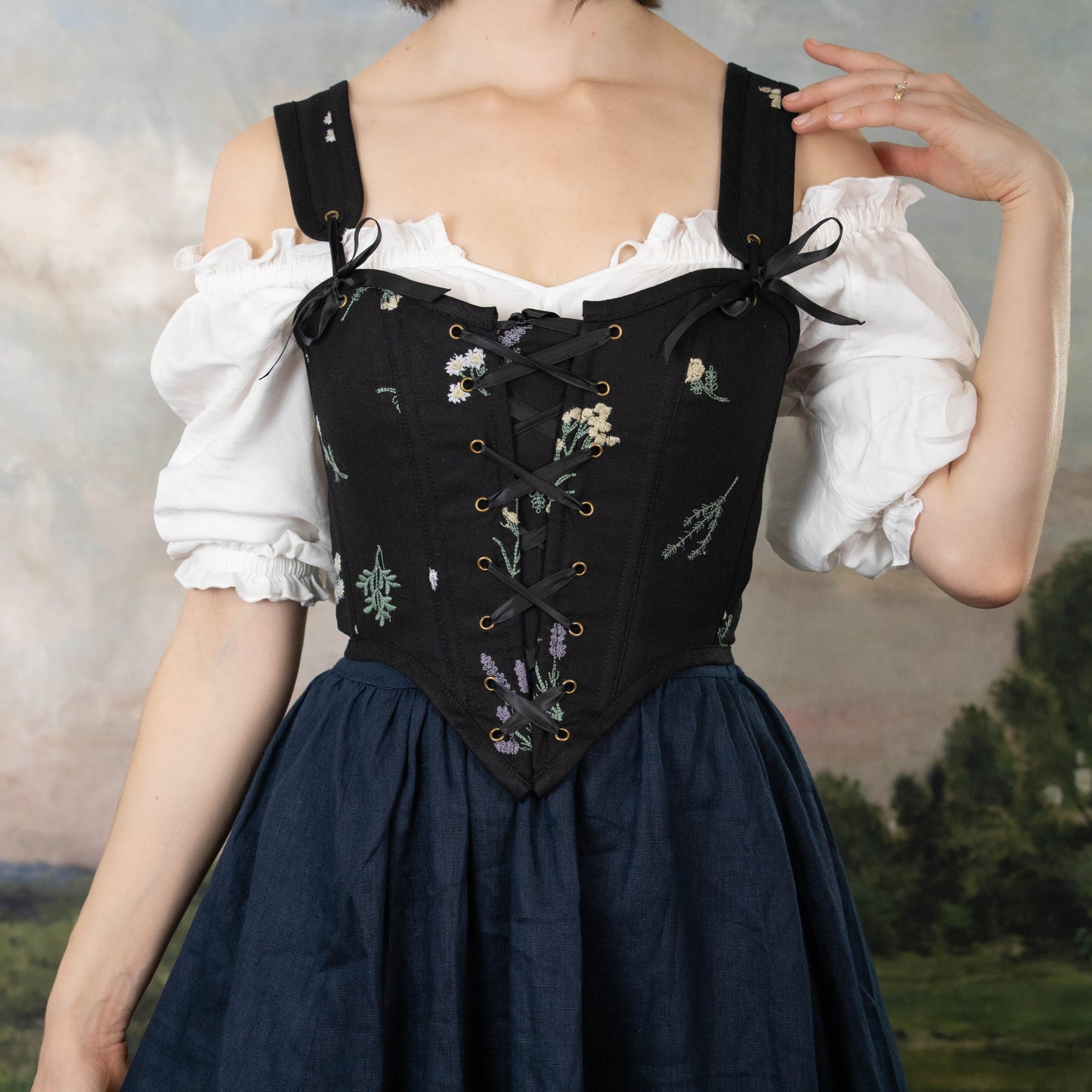 model wearing black floral renaissance faire dress