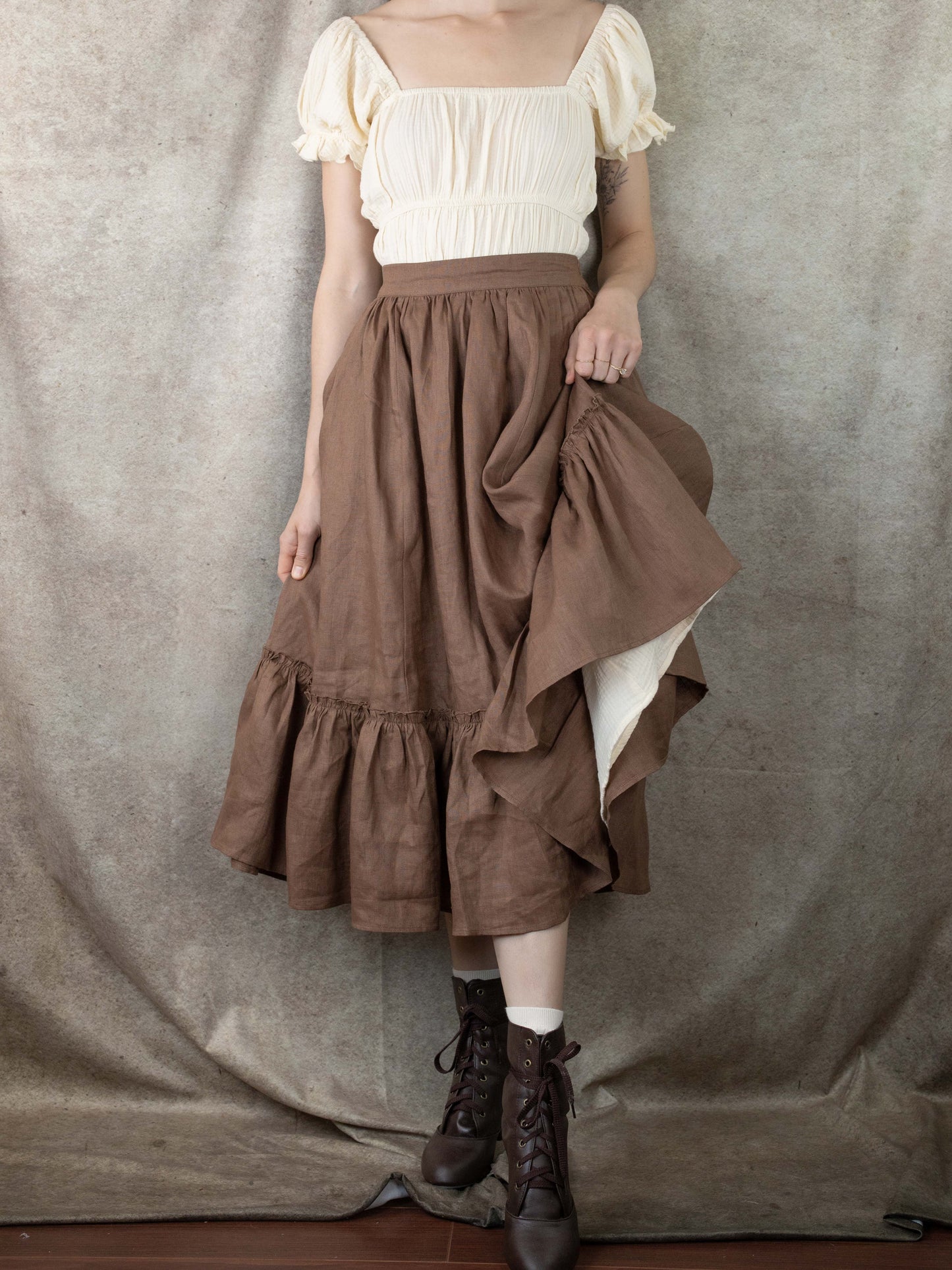 model hiking up skirt to show petticoat layers