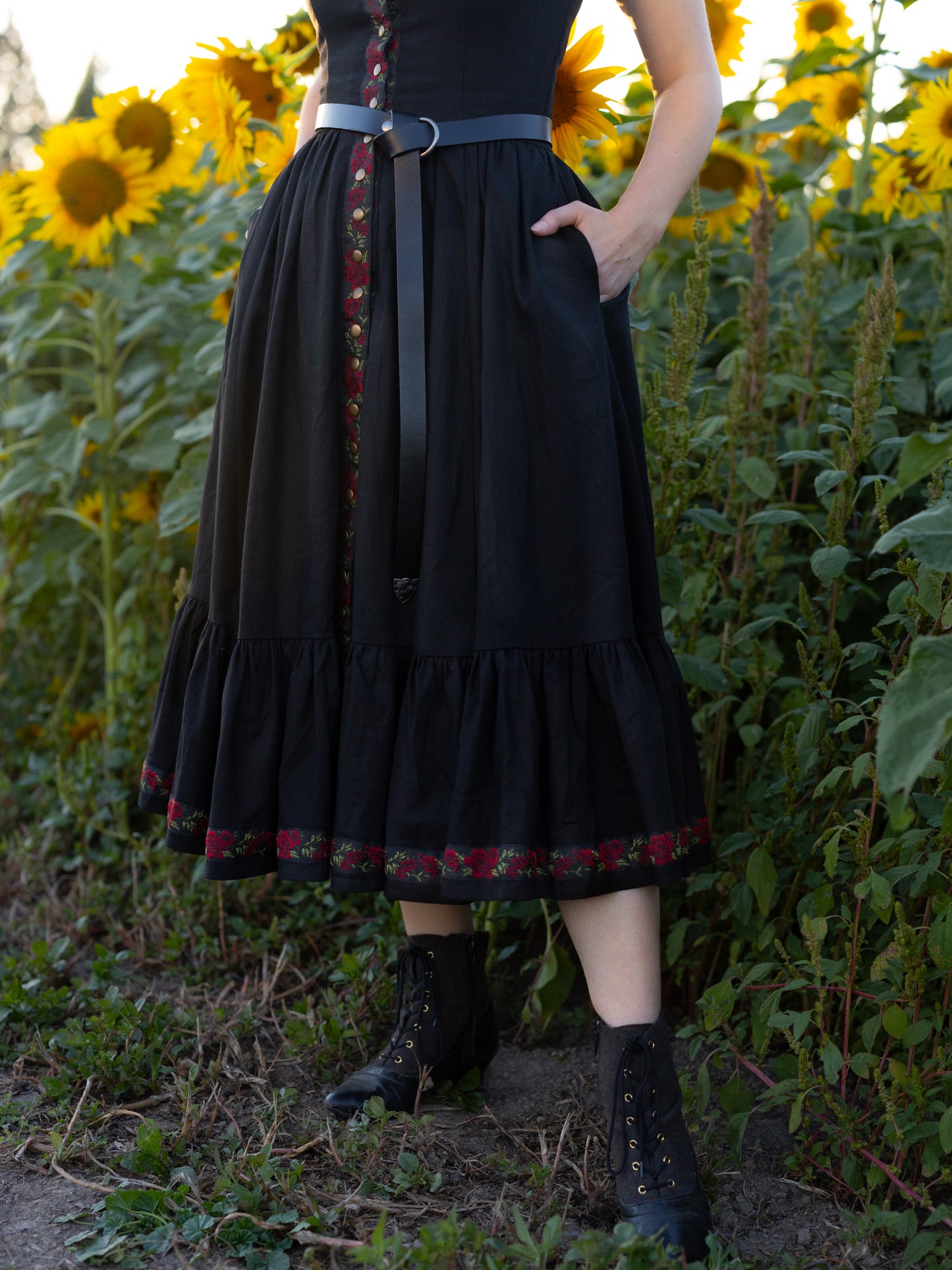 detail view of skirt showing skirt hem ruffle and red ribbon trim