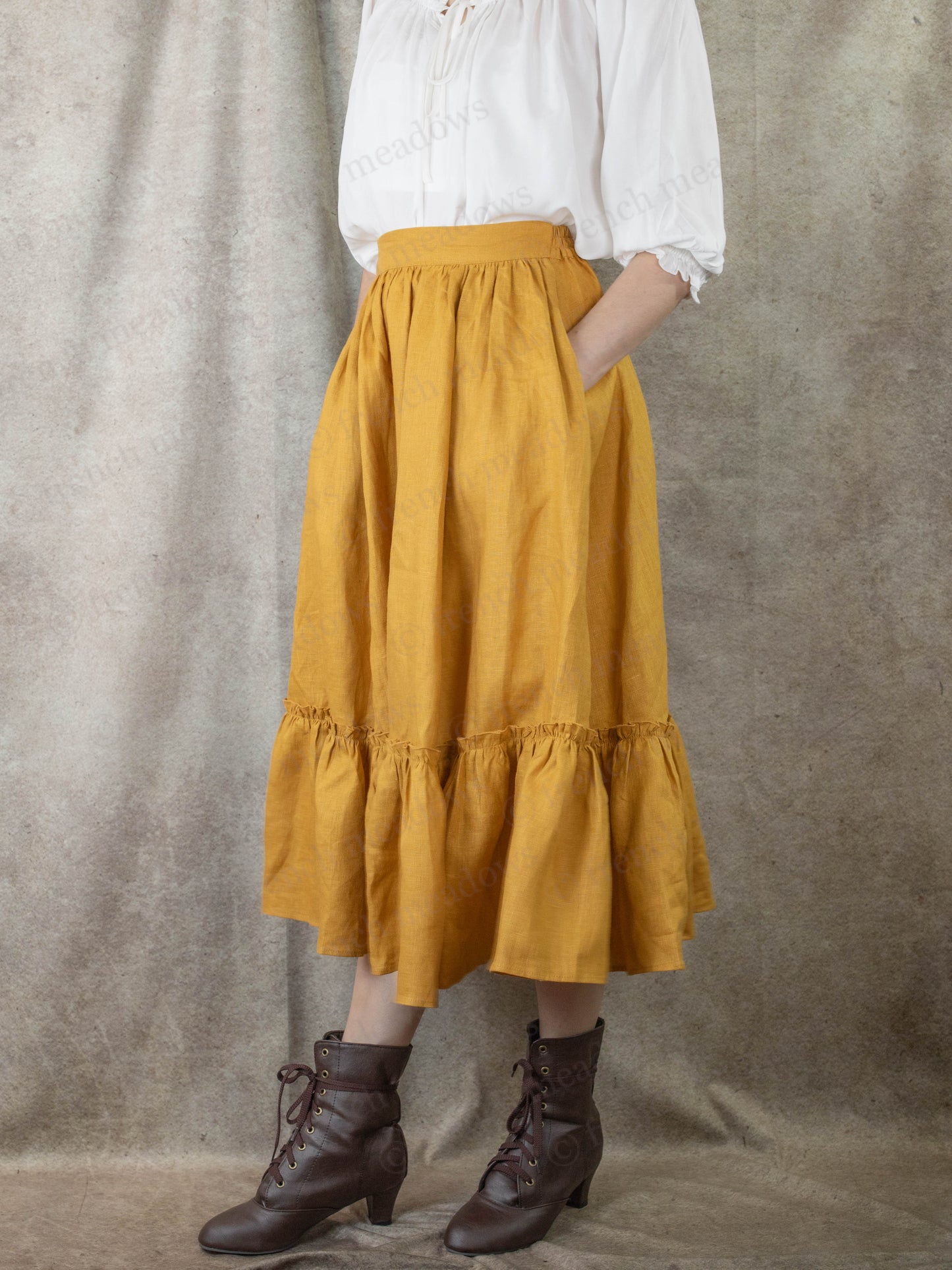 side view of model wearing yellow linen skirt